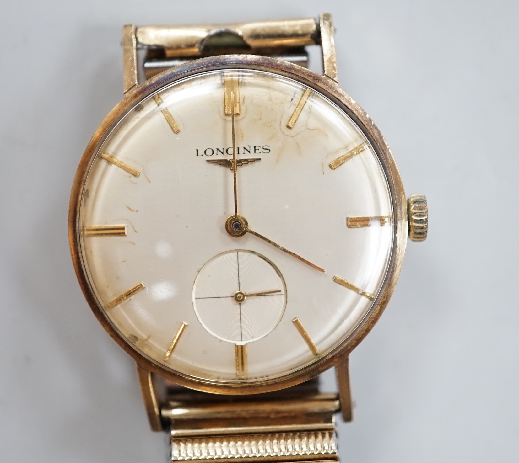 A gentleman's 9ct. gold Longines manual wind wrist watch, with engraved inscription, on an associated strap, boxed.